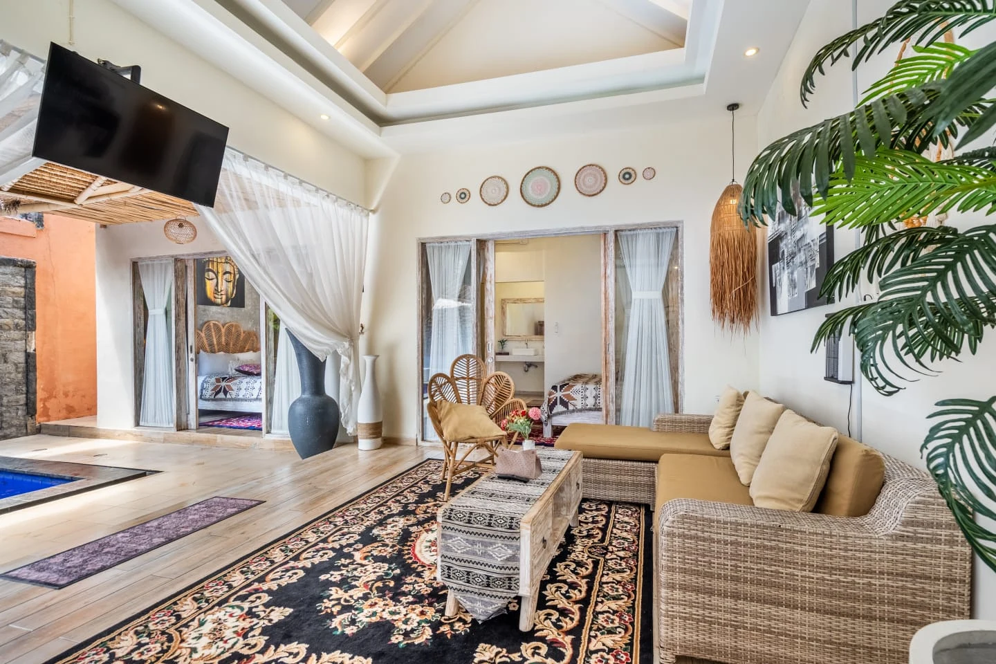 Airy tropical lounge with ceiling fan and comfortable sofas